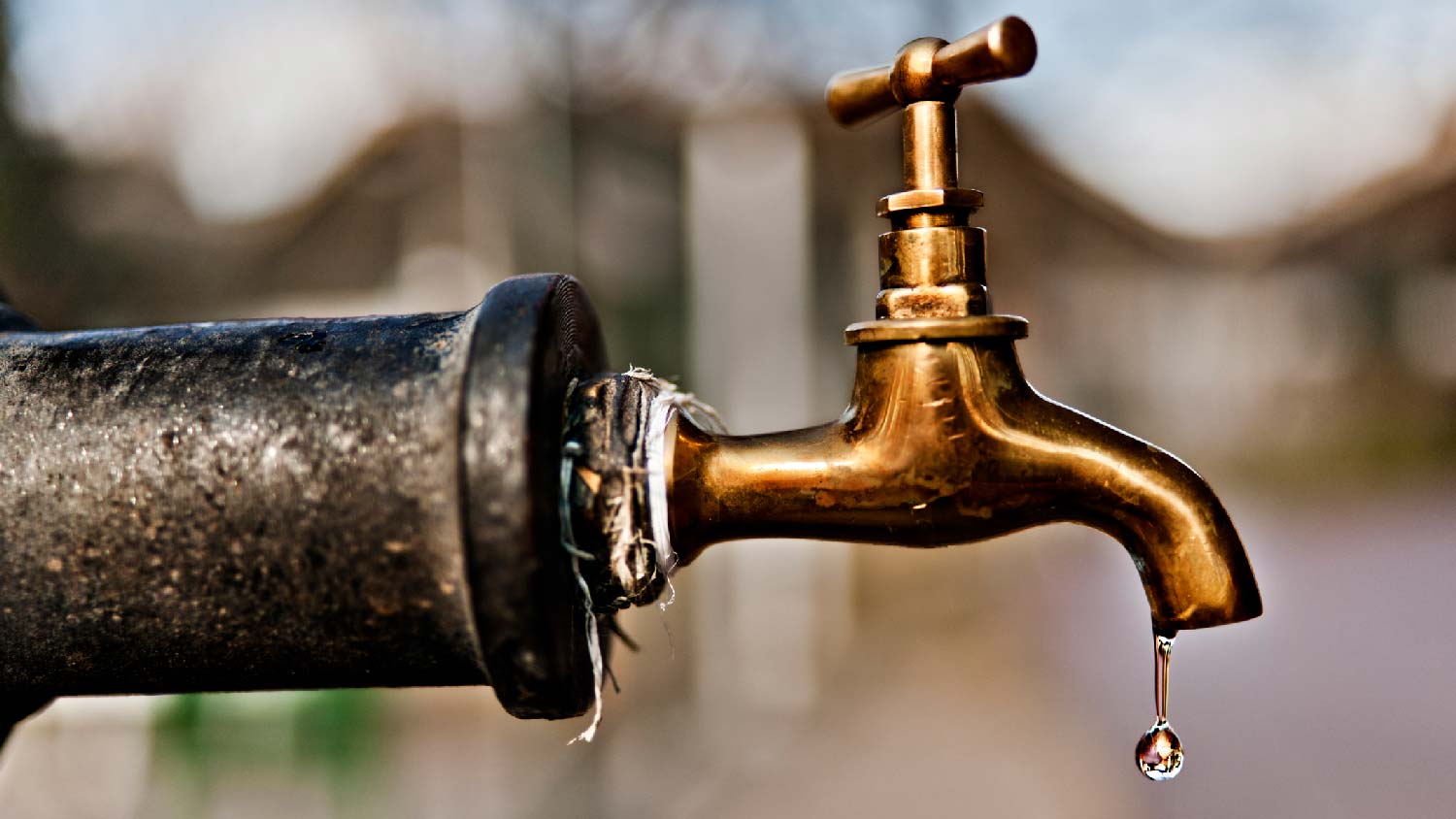 Close-up of an outdoor faucet dripping