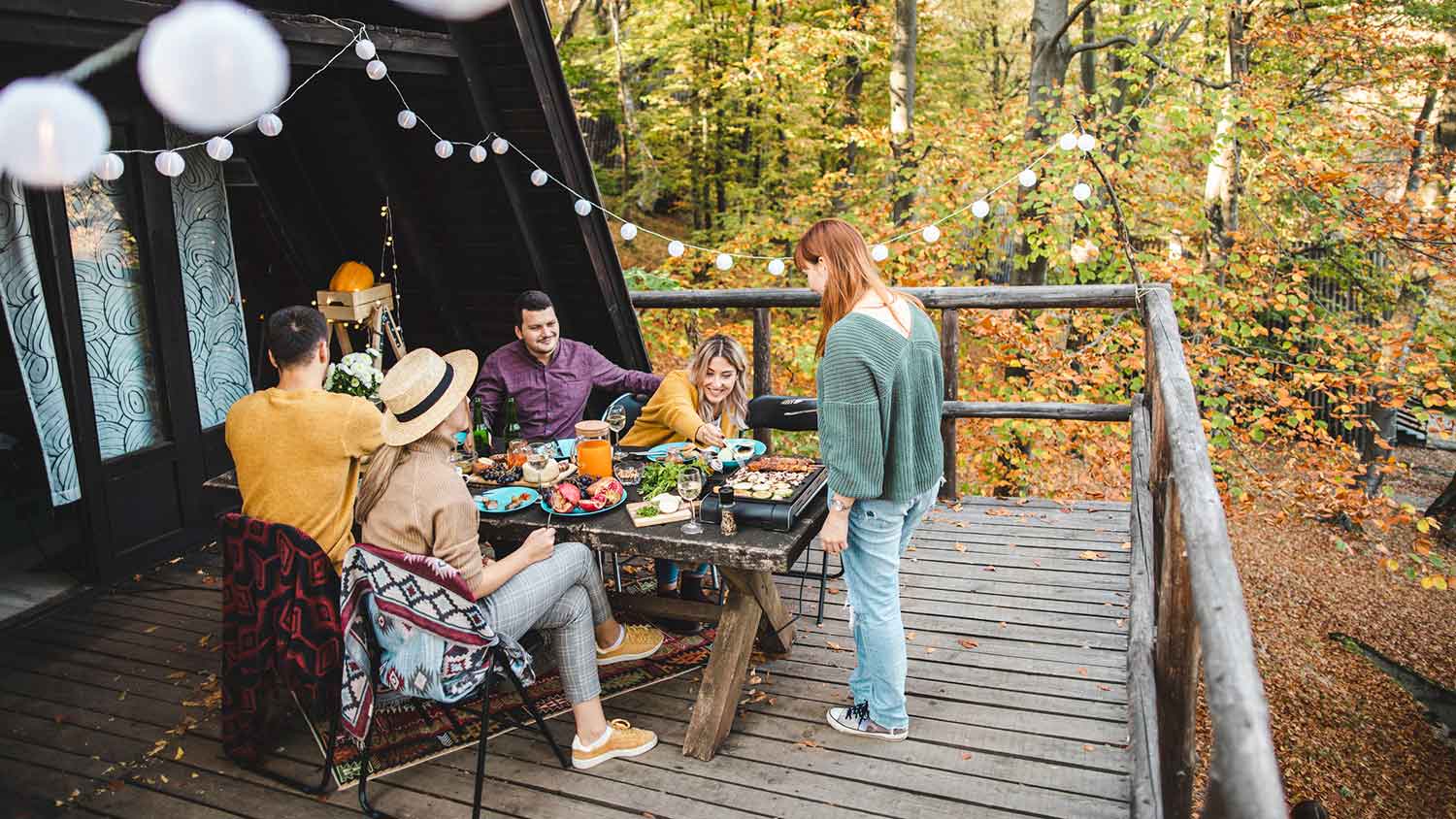 Friends sitting on the deck enjoying a BBQ