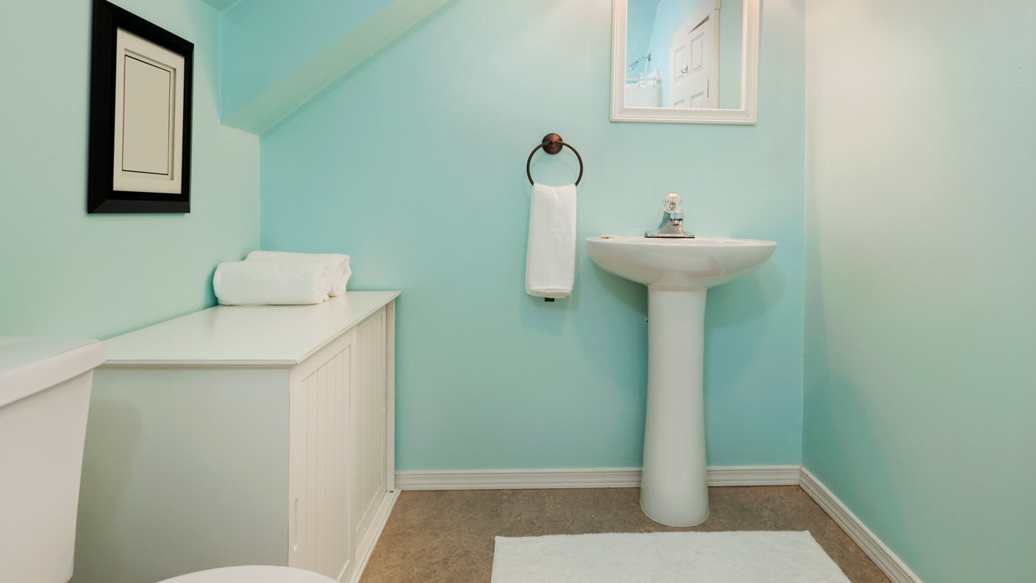 Small colorful bathroom with an oval sink.