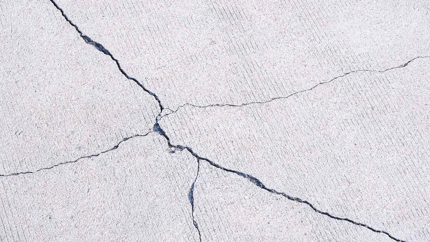 Overloading concrete crack in a concrete driveway