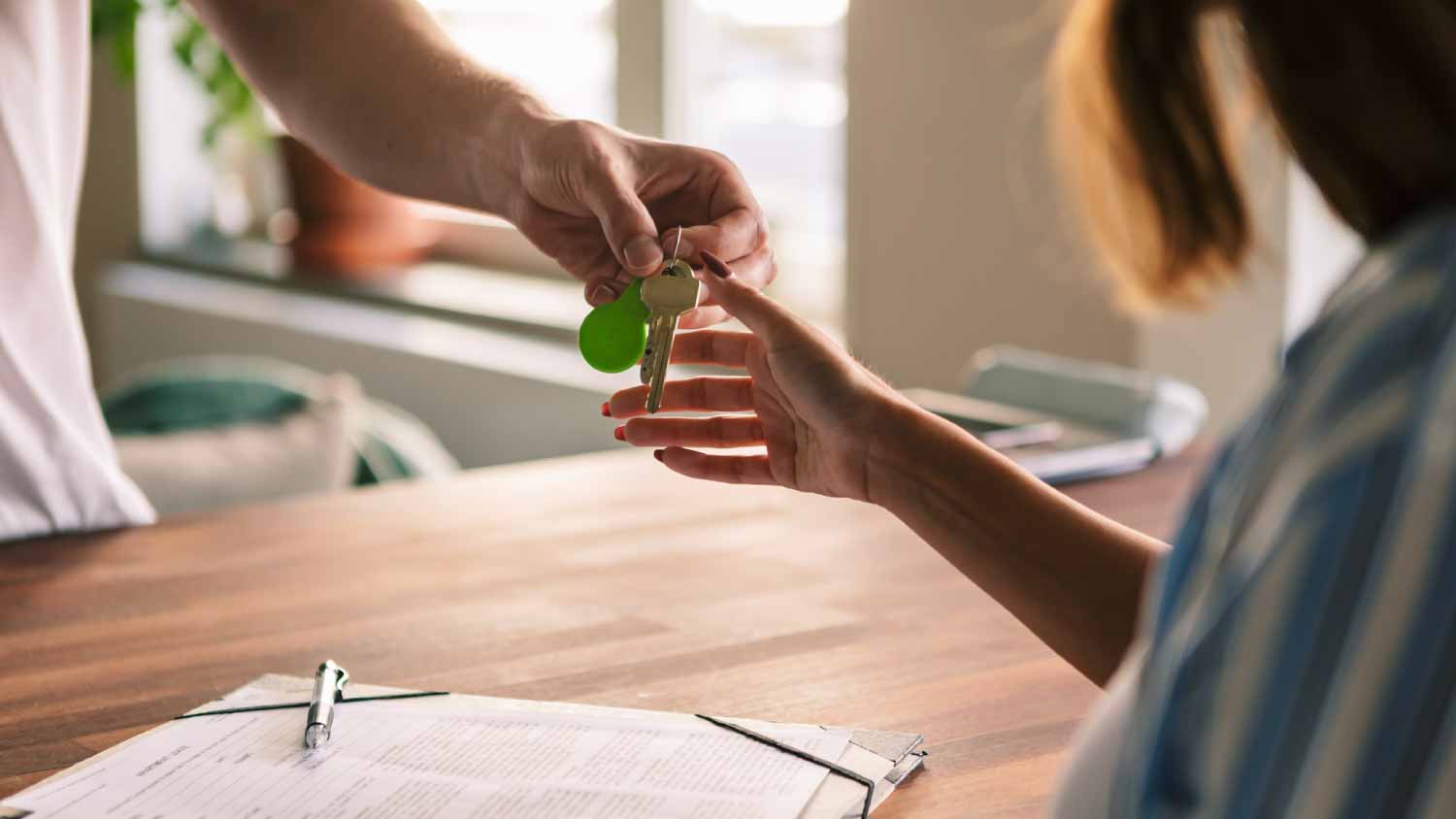 Owner giving house keys to tenant