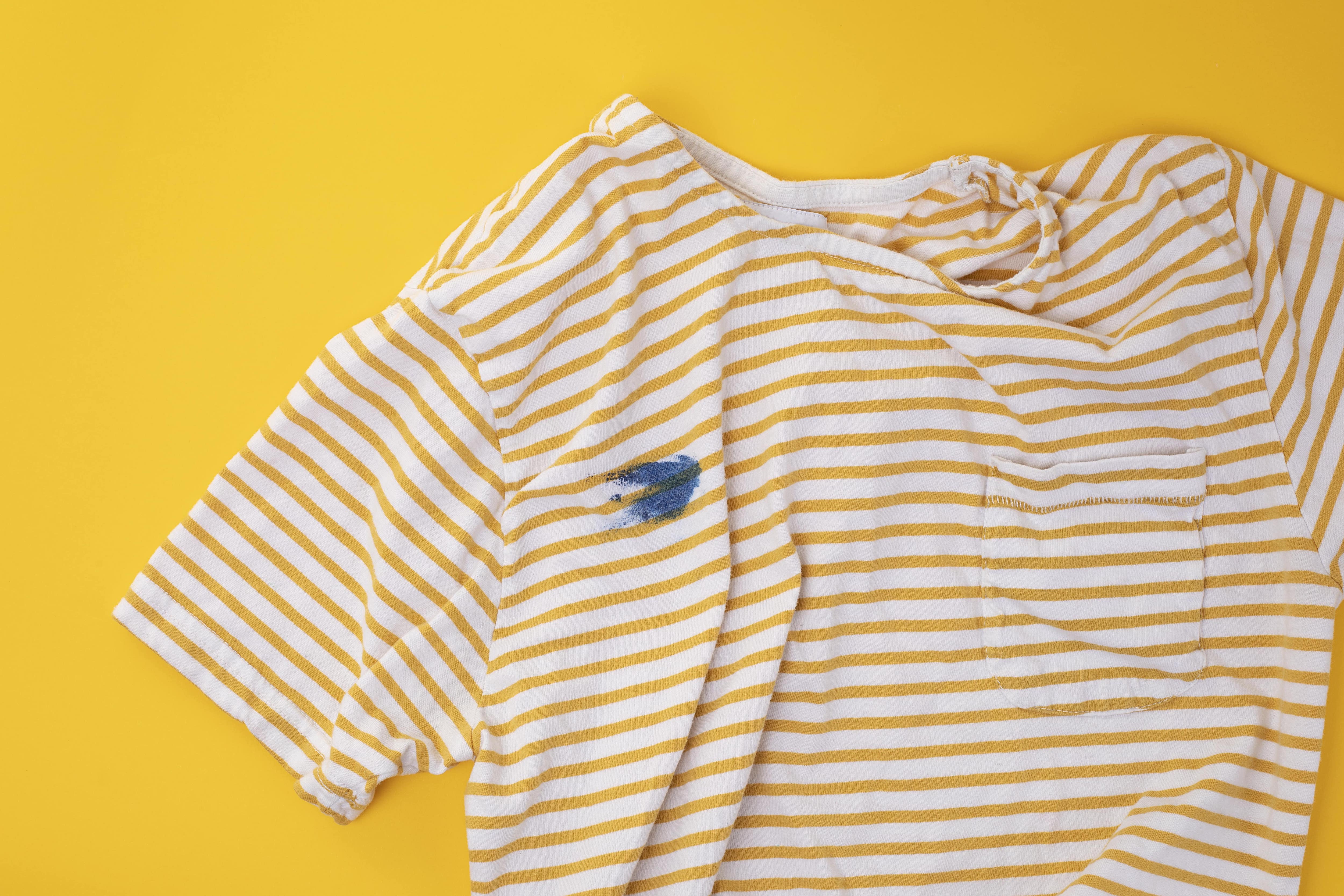 Blue paint stain on striped shirt