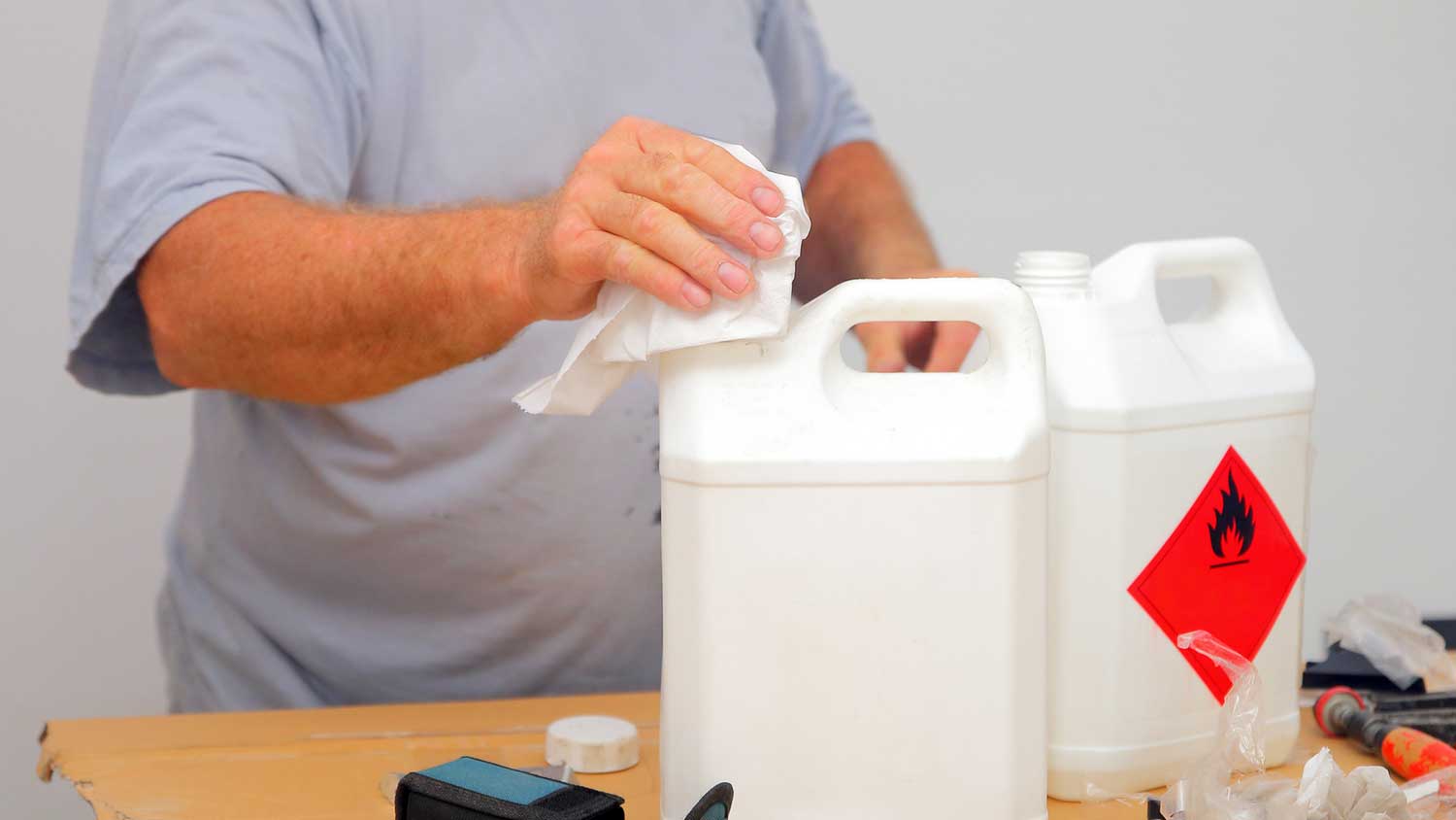 Painter using a chemical paint remover 