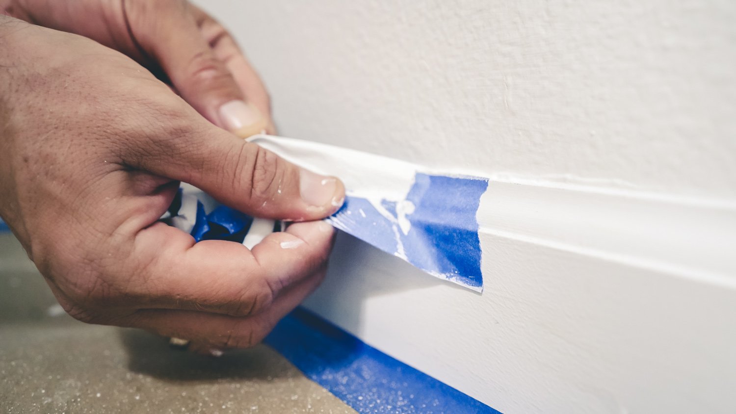 Removing masking tape from molding