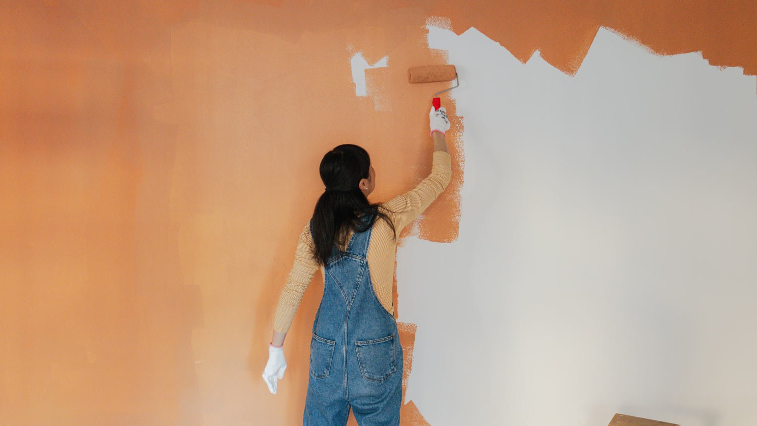 woman painting living room