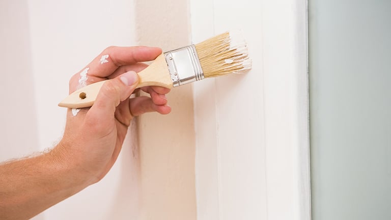 Painting trim white next to a blue wall