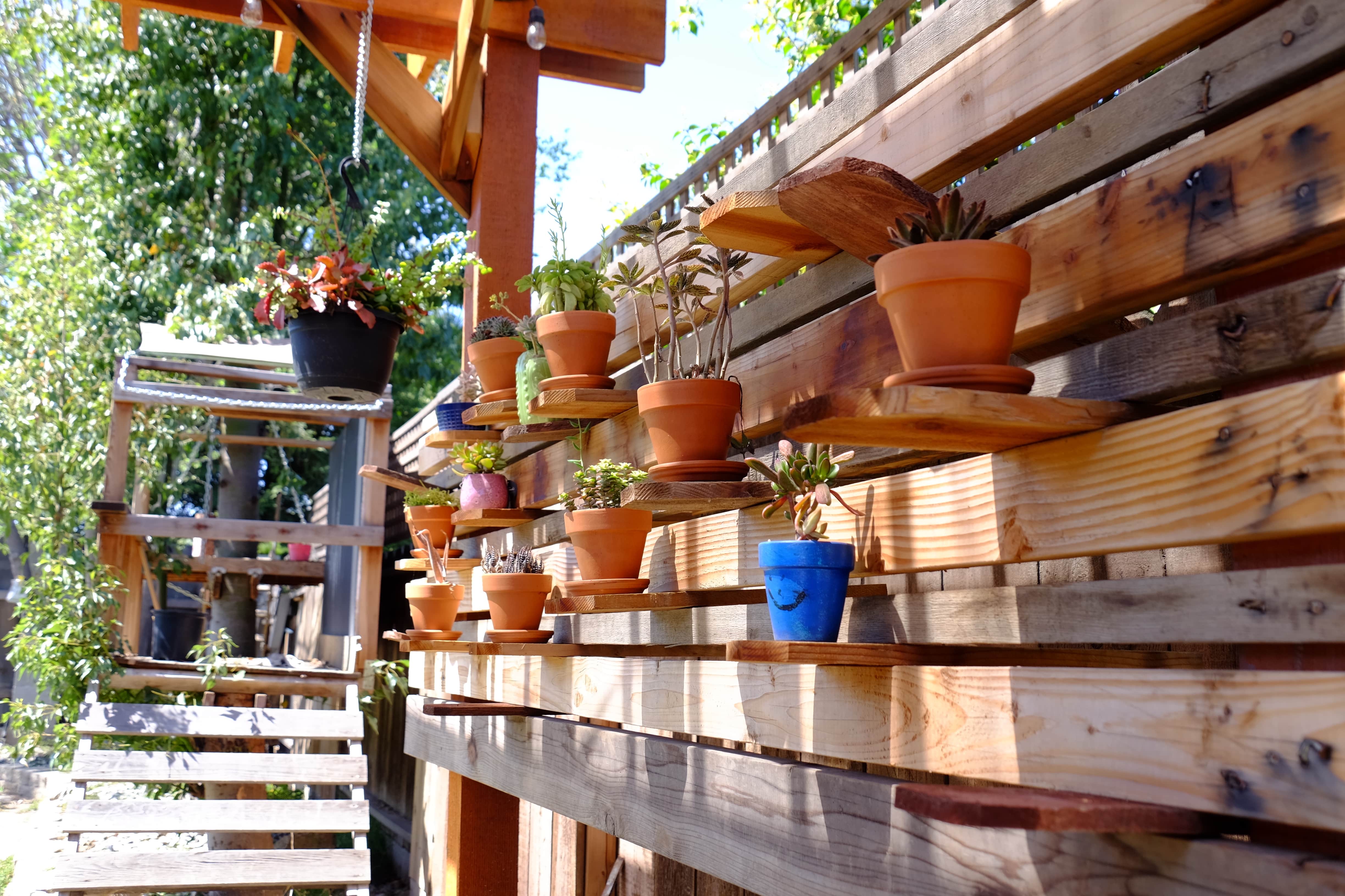 Wood pallet fence with potted plants