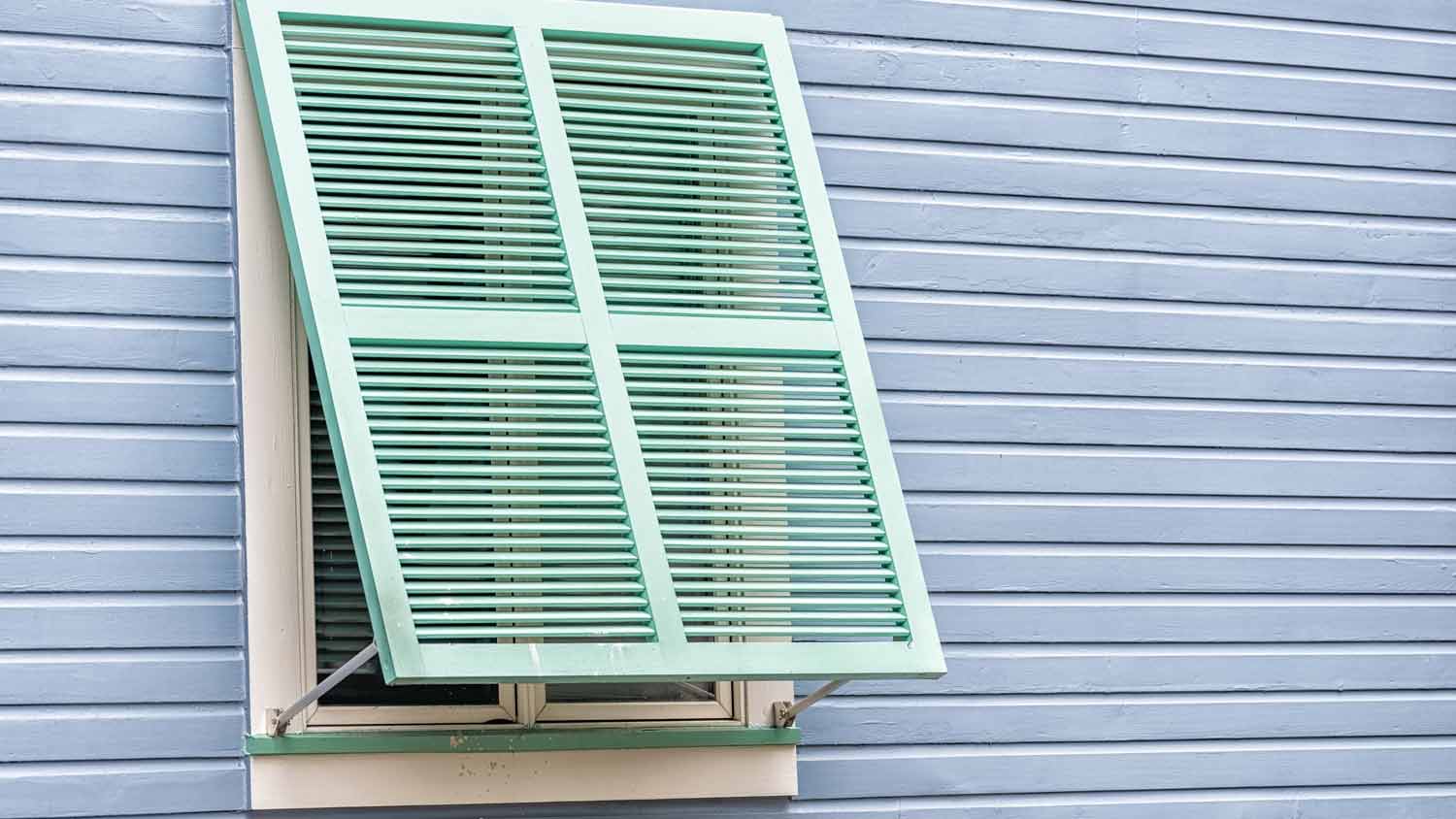 pastel green hurricane shutters 