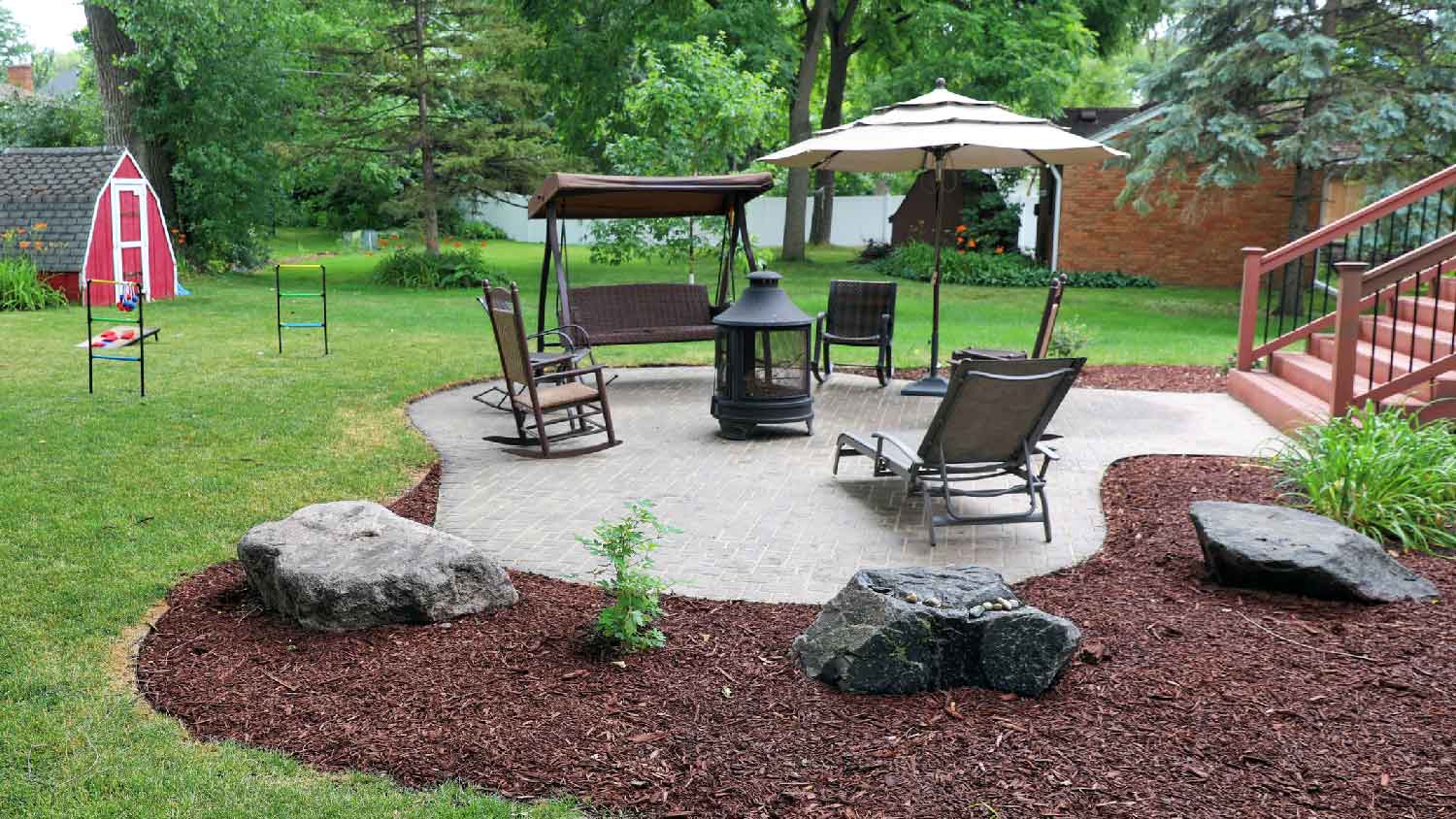 A patio with mulch for landscaping the yard