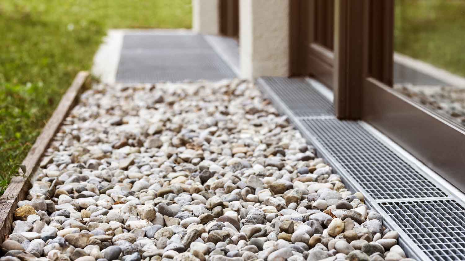 Pebbles and a drainage system on the exterior of a house