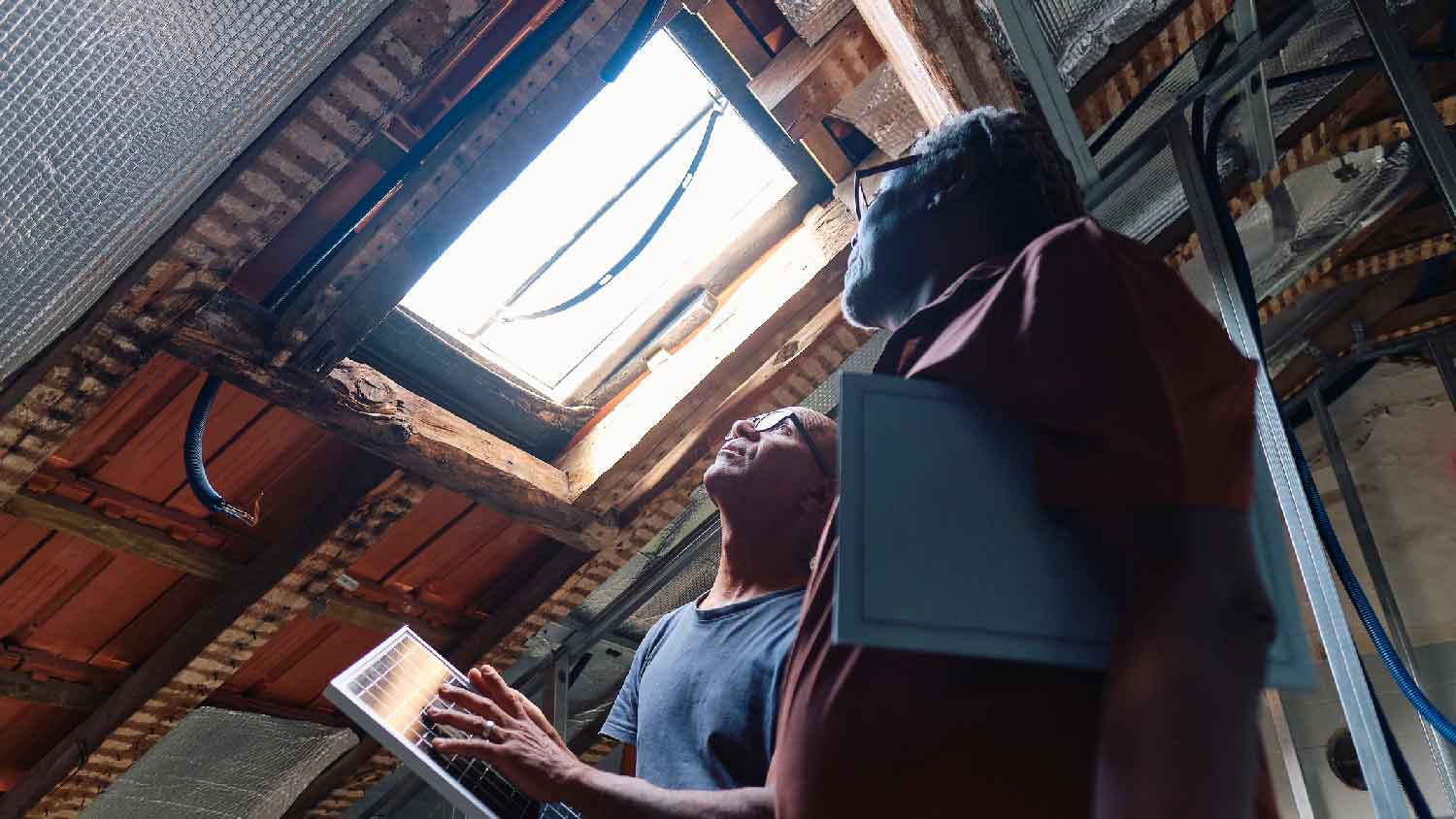 People inspecting an attic for leaks