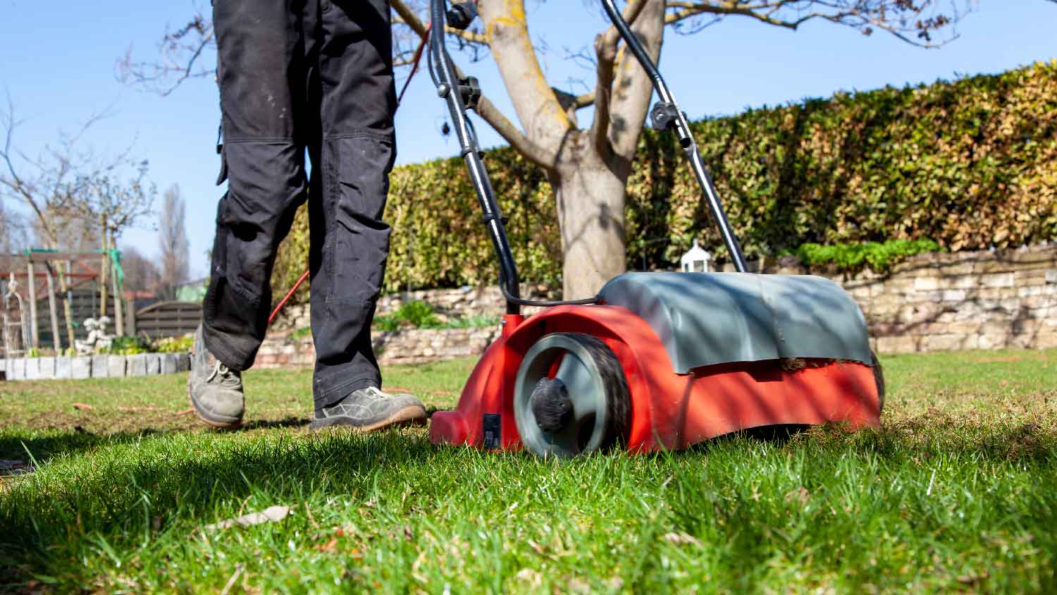 A person aerating the lawn