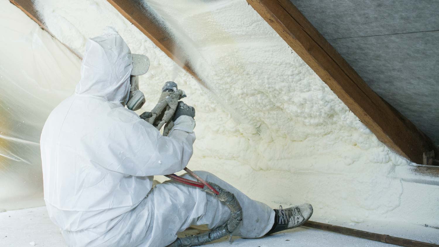  A person applying spray foam insulation