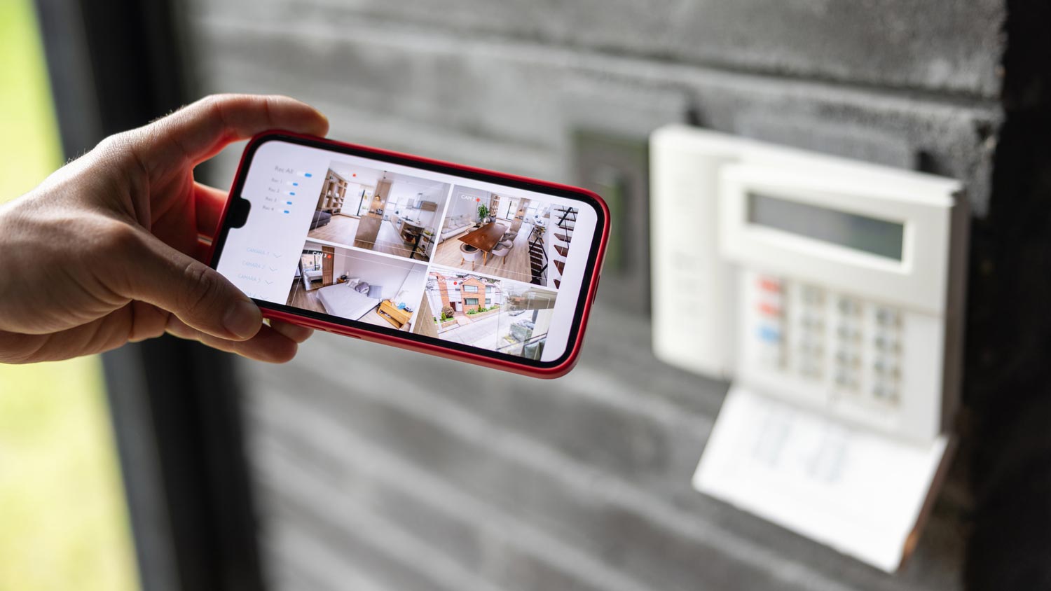 A person checking the cameras of his house on a phone