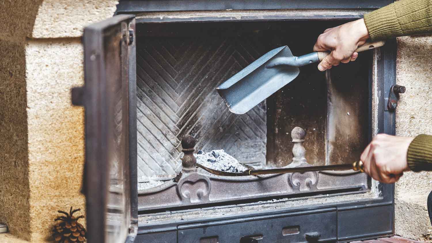 A person cleaning a brick fireplace