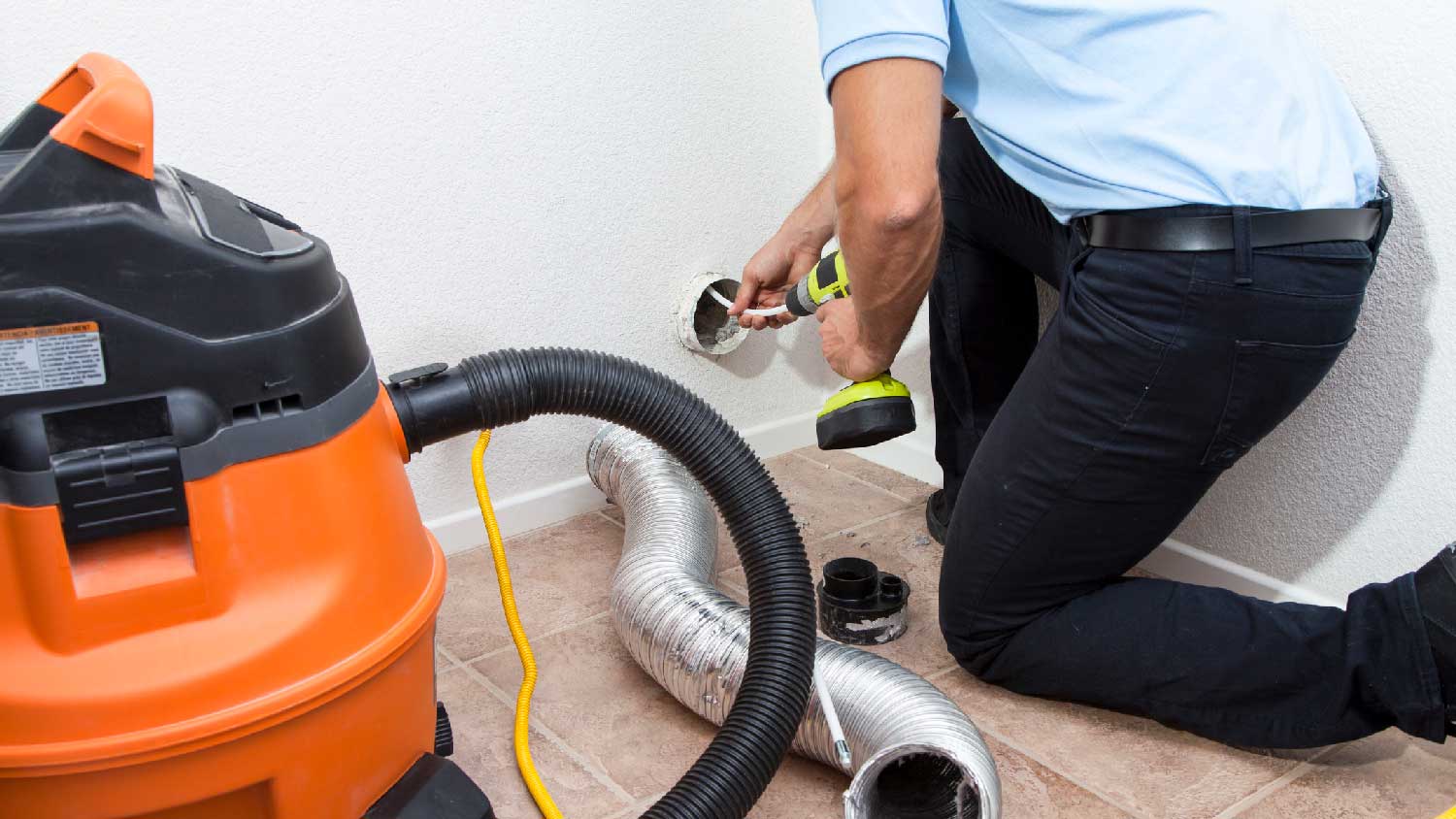 A person cleaning a dryer vent