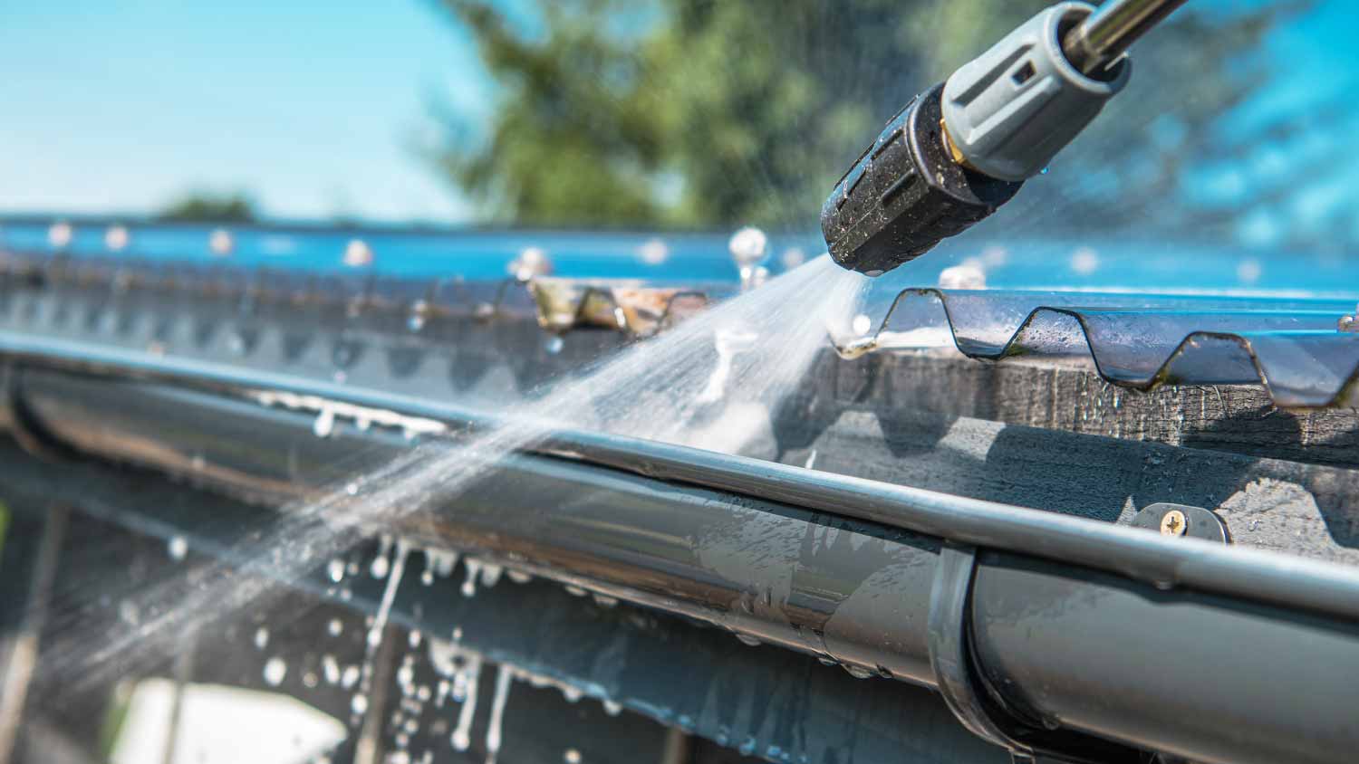 A person cleaning rain gutters