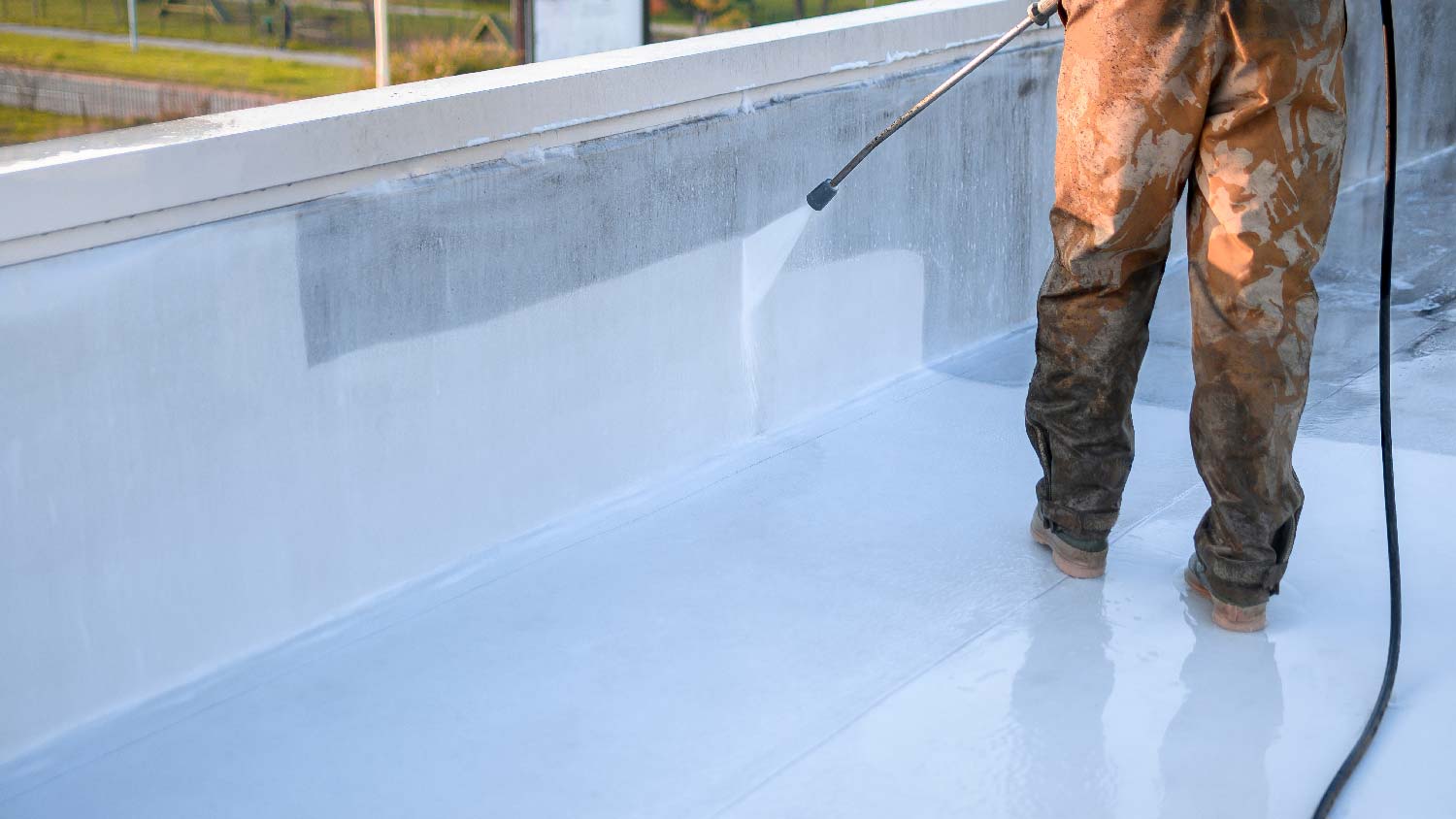 A person cleaning TPO roofing