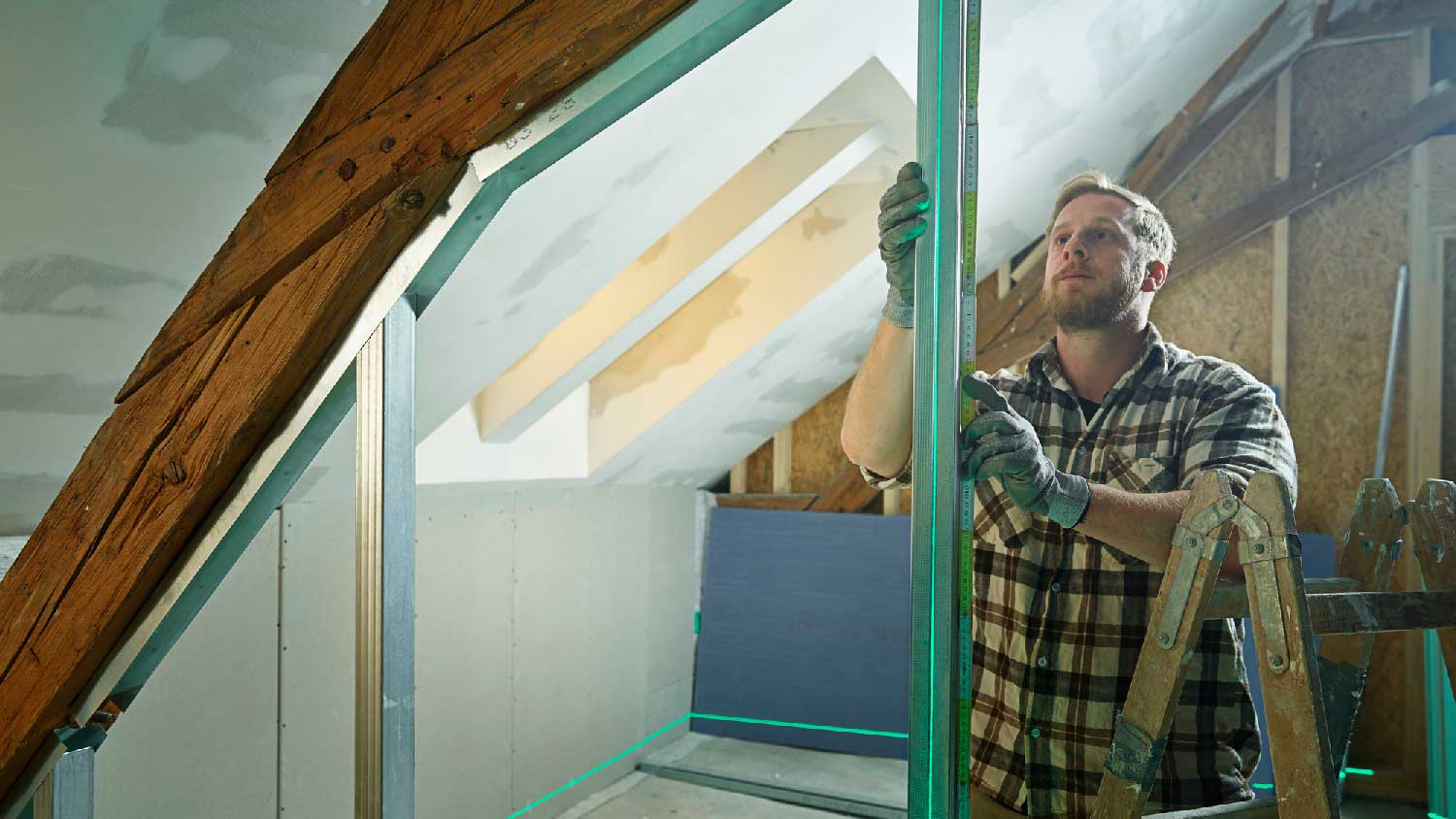 A person converting an attic into a loft