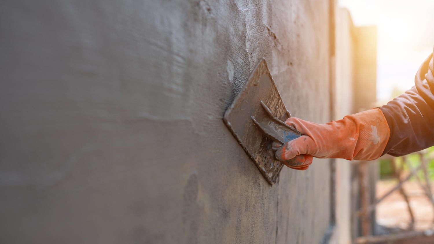 A person fixing a foundation crack