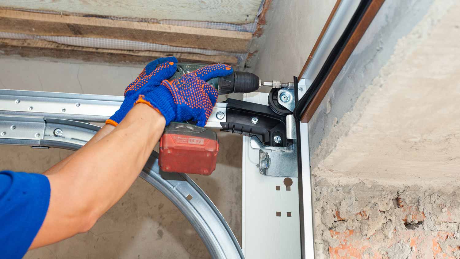 A person fixing garage door springs