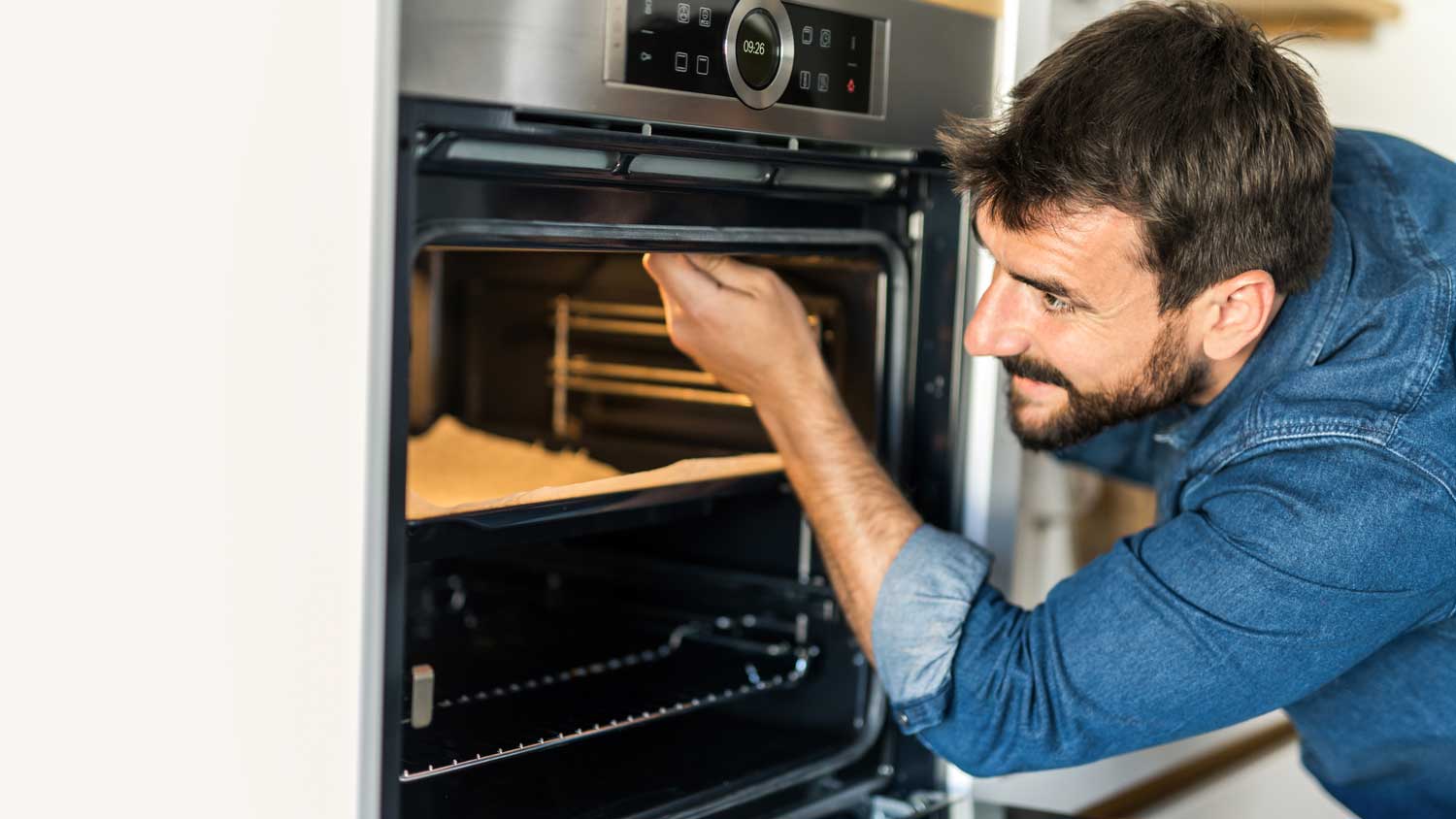 A man is fixing an oven