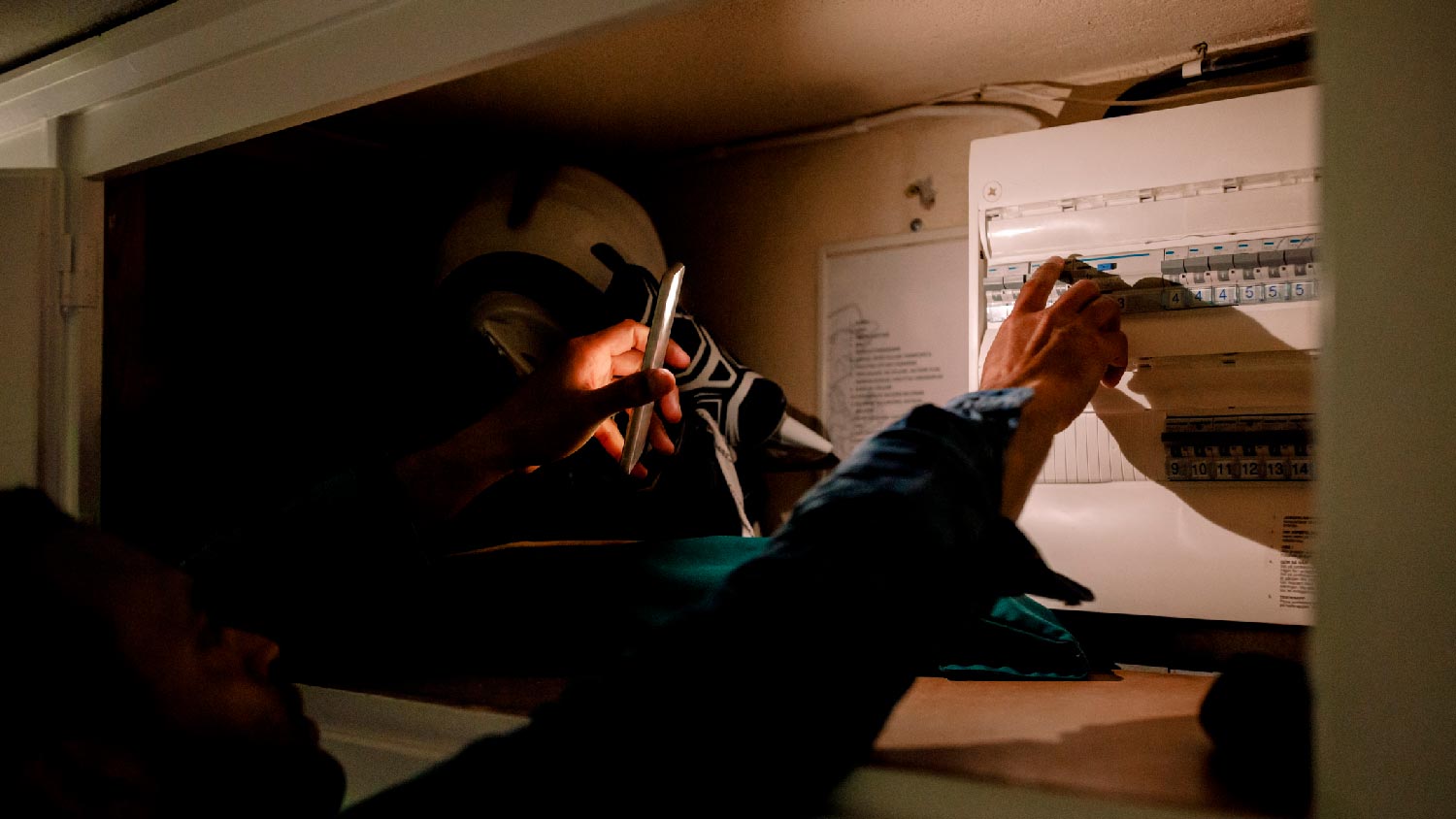 A person inspecting an electrical panel