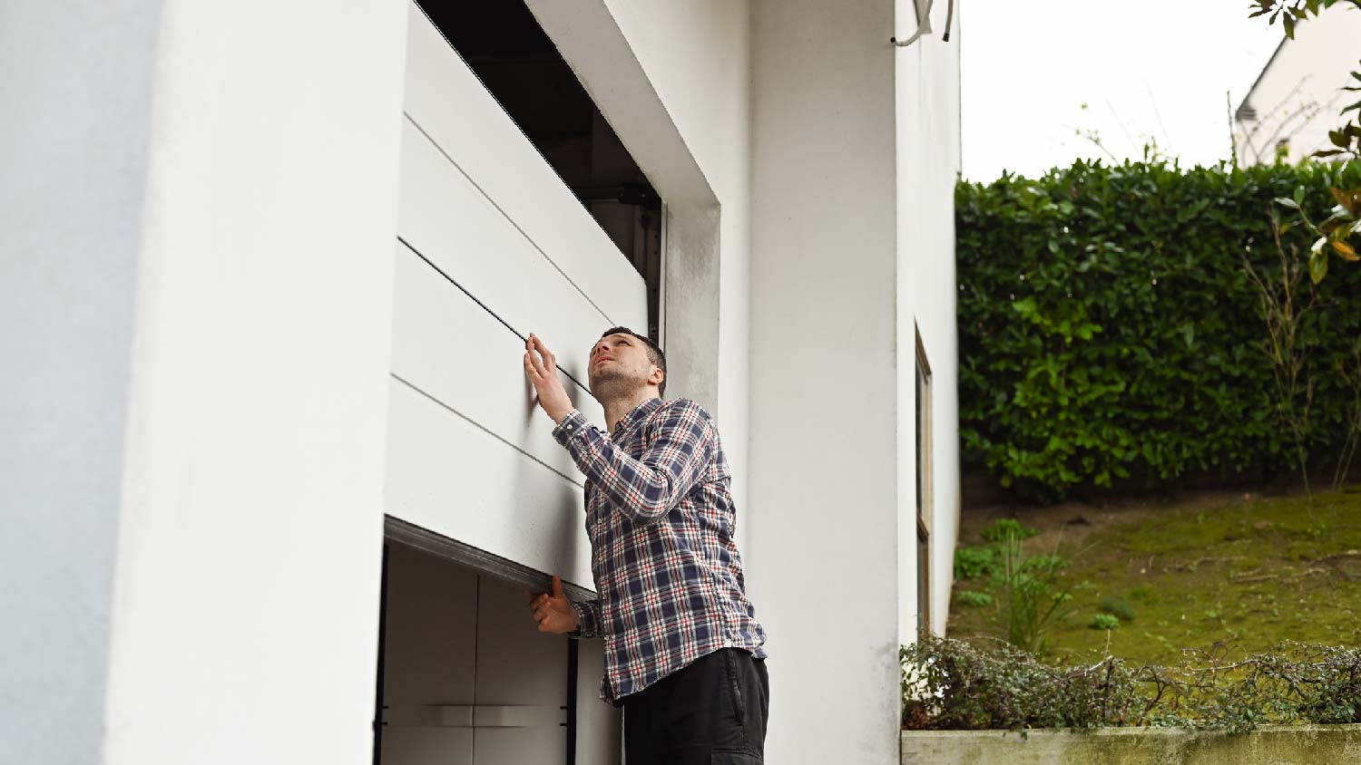 A person inspecting a garage door