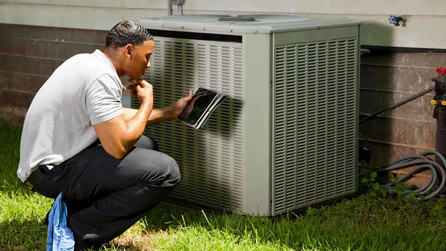 A person inspecting a HVAC system