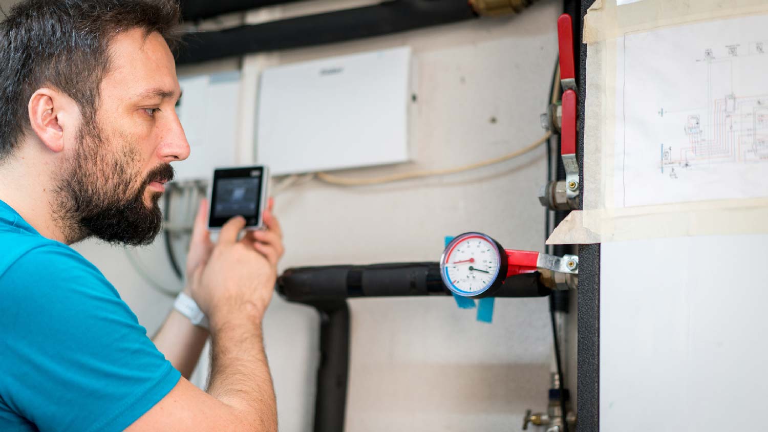 A person inspecting a house’s plumbing system