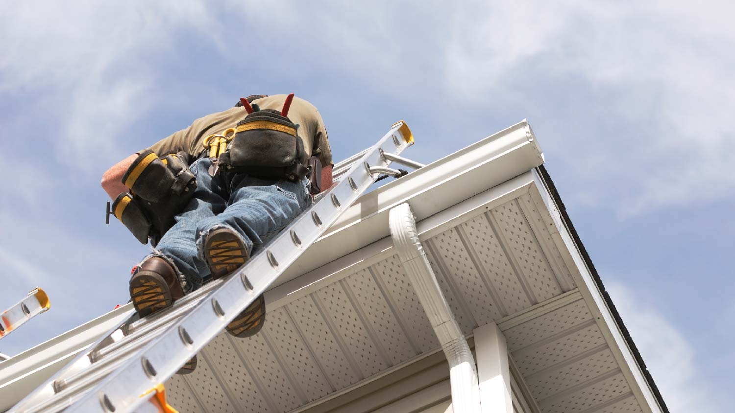 A person inspecting a soffit