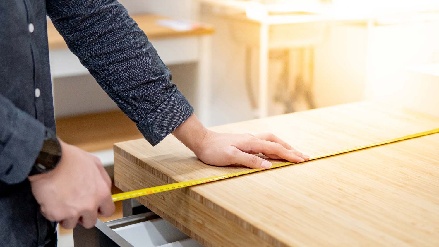 A person installing a butcher block countertop