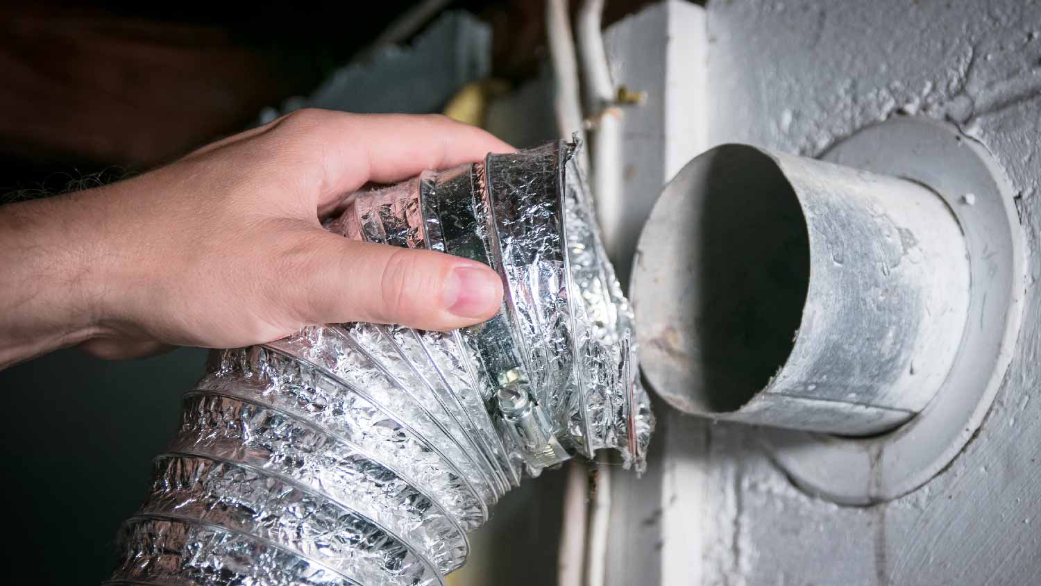 A person installing a flexible ductwork