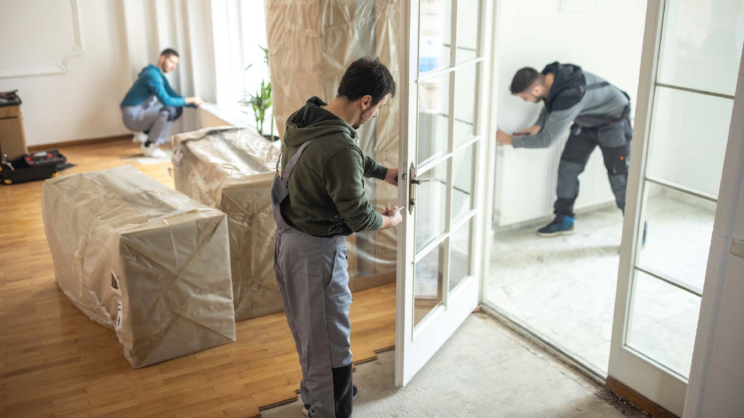 A person installing a french door