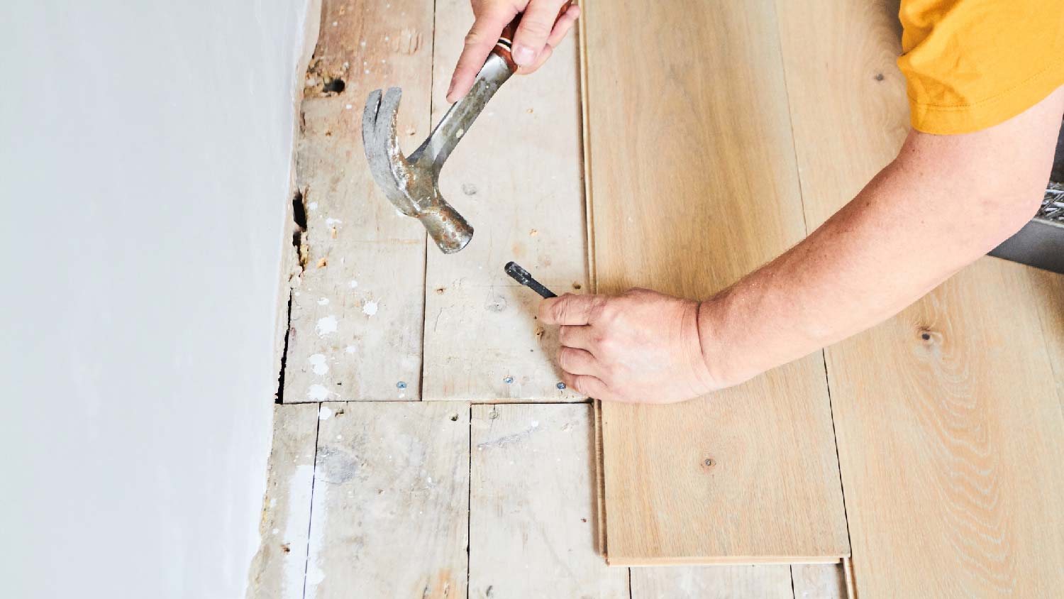 A person installing new hardwood flooring