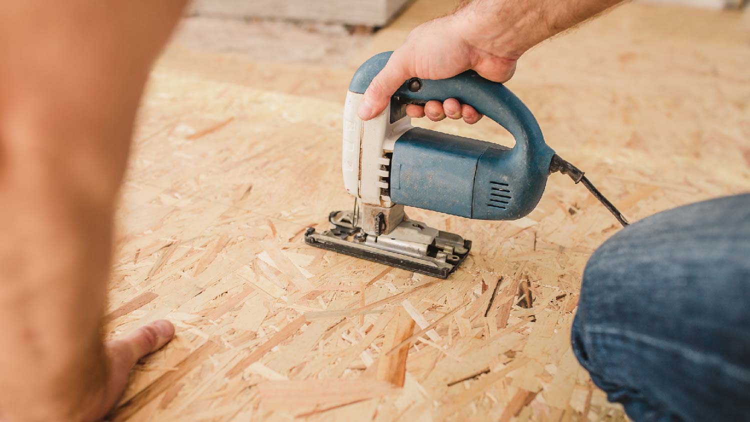 A person installing an OSB sheet