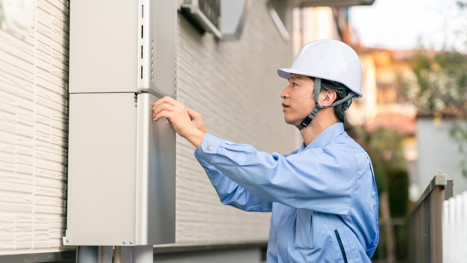 A person installing a tankless water heater