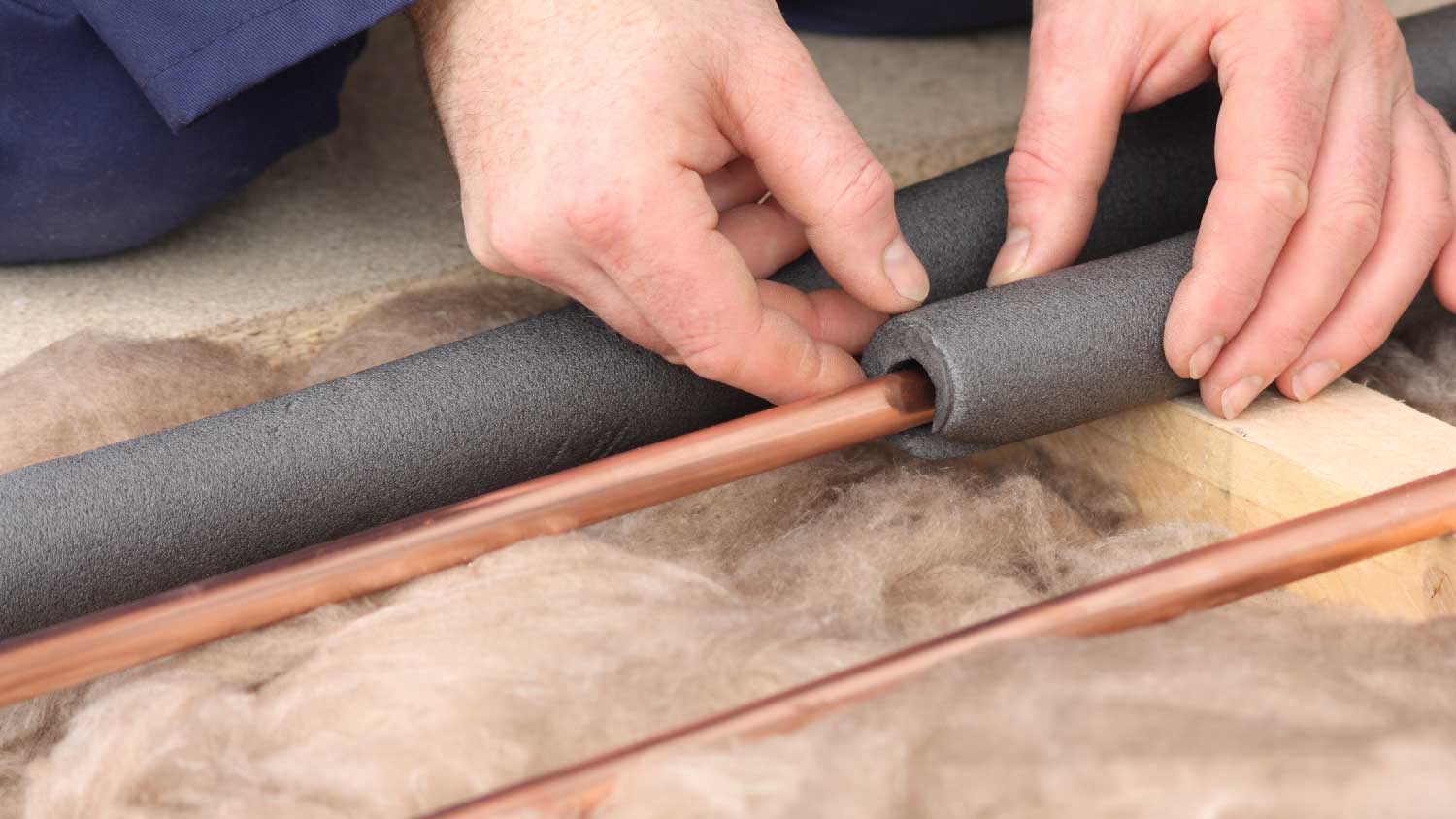 A person insulating water pipes