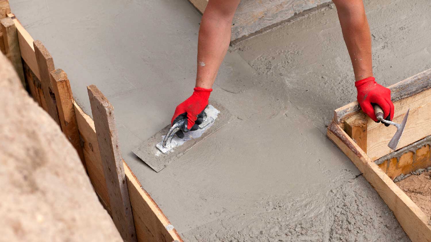 A person leveling concrete footing