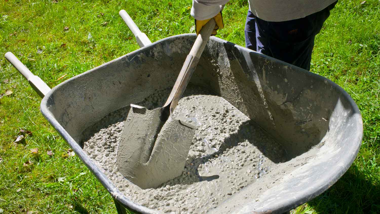 A person mixing mudjacking cement slurry