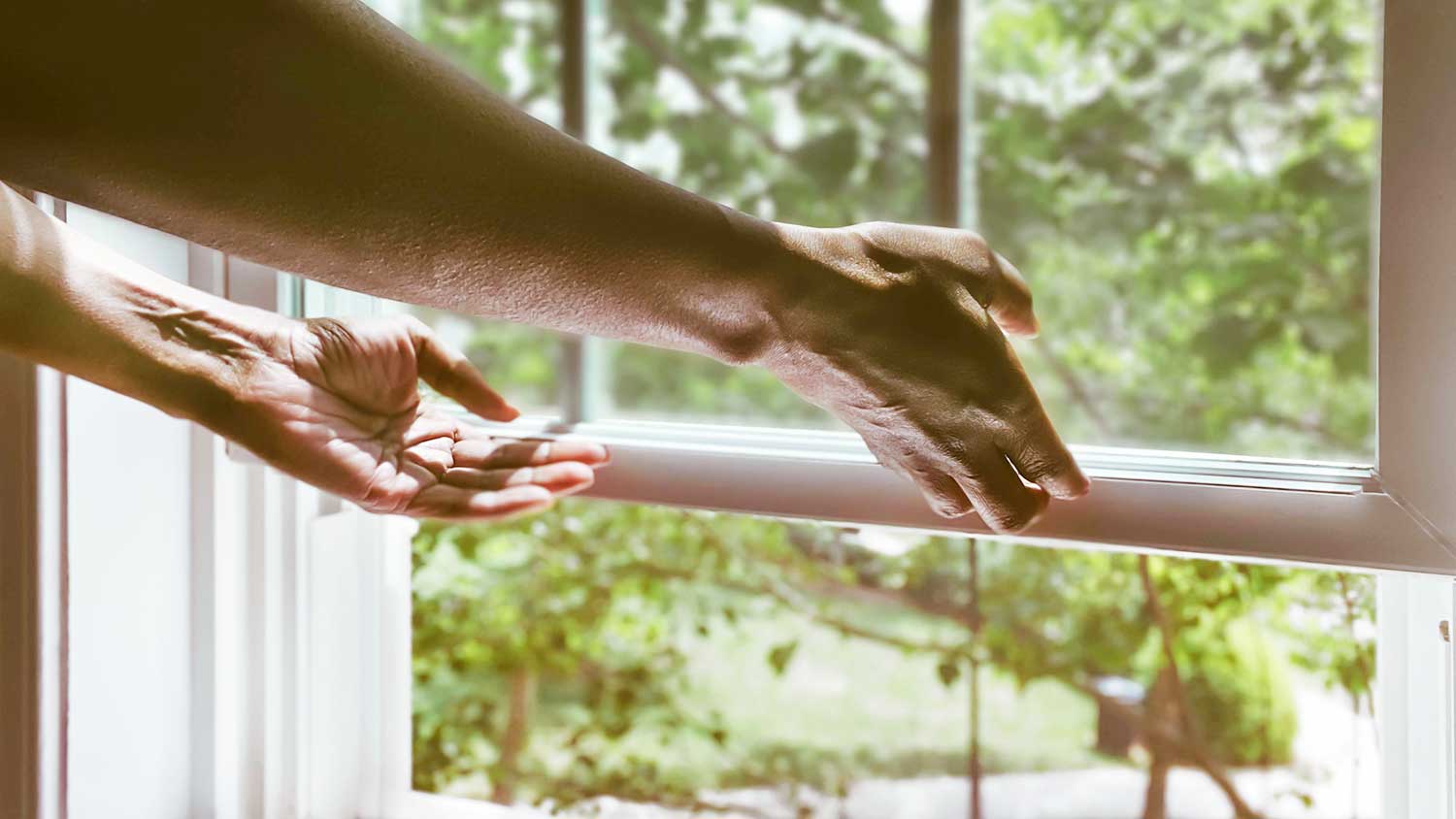 Woman using window lift to open a window 