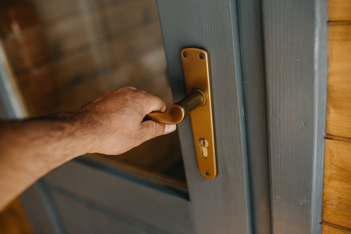 A hand holding a door knob