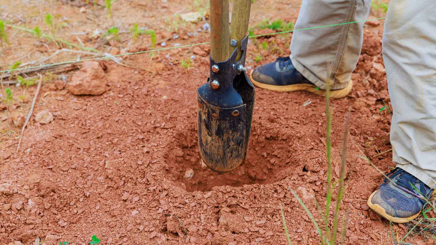 A person opening a hole in the ground