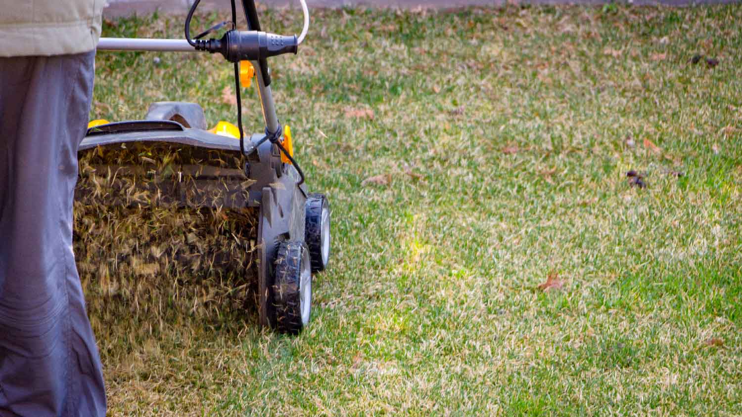 A person operating a core aerator