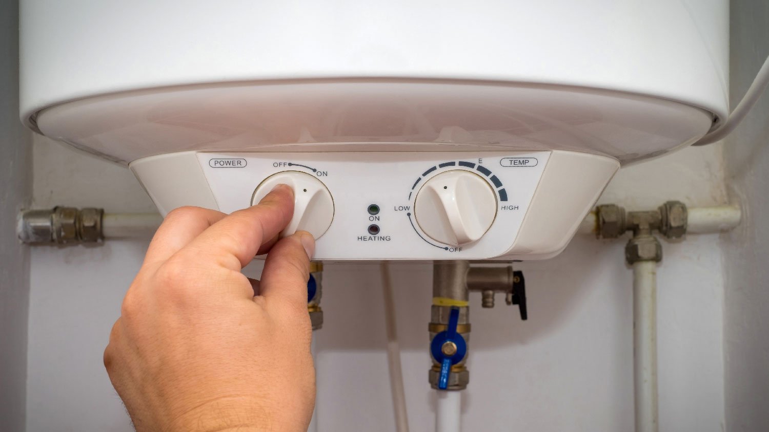 A person operating an electric water heater