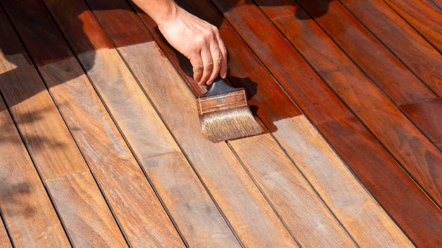 A person refinishing hardwood floors