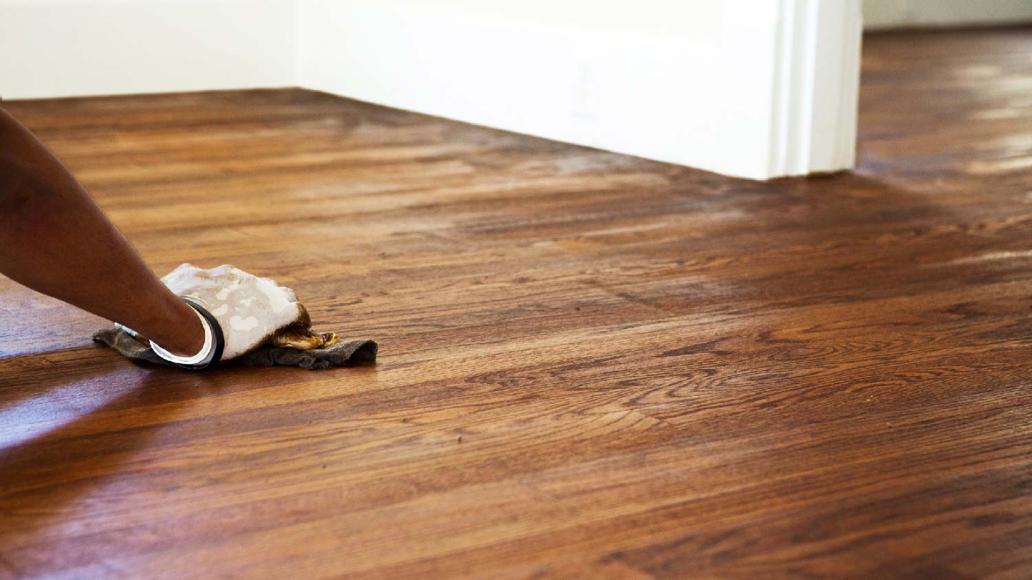 A person refinishing a wood floor 