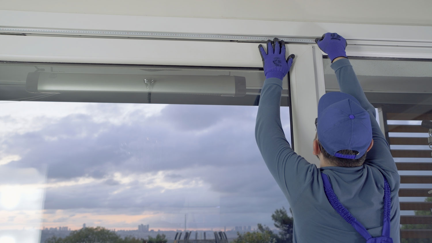 A person reinforcing a window