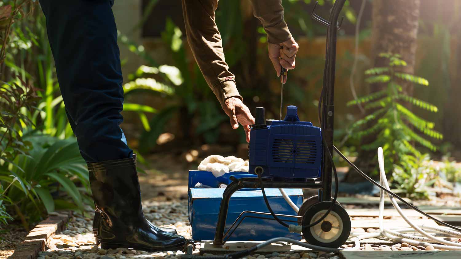 A person repairing a power washer