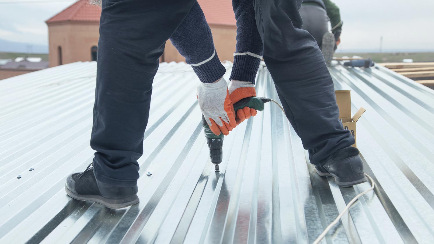 A person repairing a steel roof